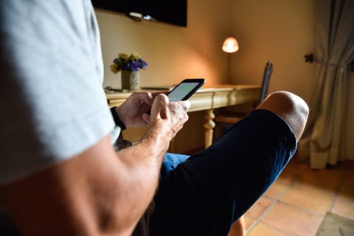 Man-Mobile-Phone-Hotel-Room